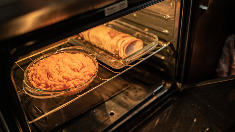A close up of food being warmed in an oven