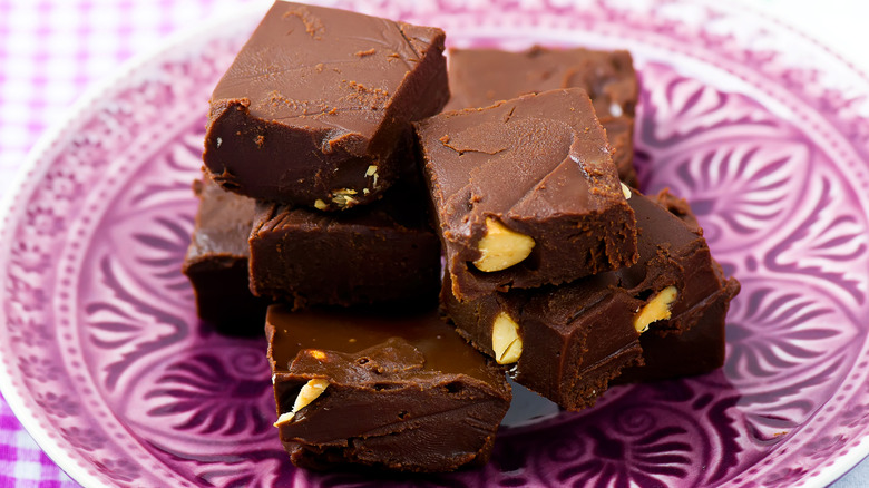 A pile of nut fudge squares on a plate