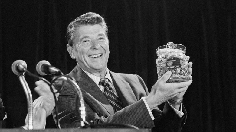 Ronald Reagan holds a crystal jar of jellybeans
