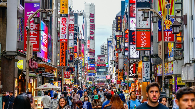 A crowd walking through Tokyo's Shinjuku district