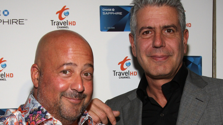 Anthony Bourdain with hand on shoulder of Andrew Zimmern