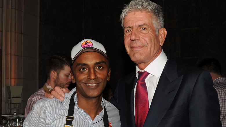 Anthony Bourdain embracing Marcus Samuelsson