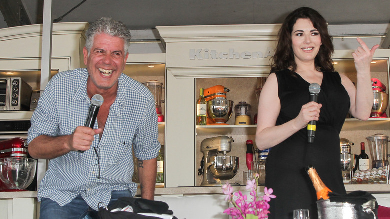 Anthony Bourdain and Nigella Lawson laughing on stage