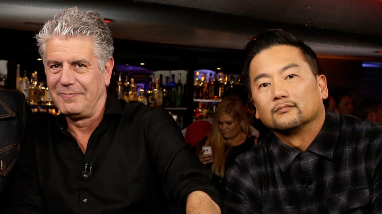 Anthony Bourdain and Roy Choi at a bar looking at camera