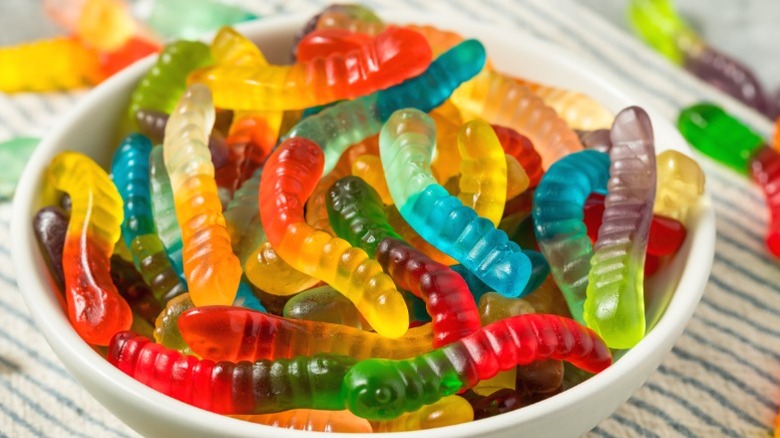 Multicolored gummy worms in a bowl.