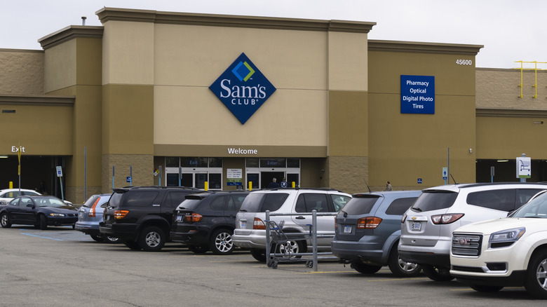 Parking lot outside of Sam's Club filled with many cars on overcast day