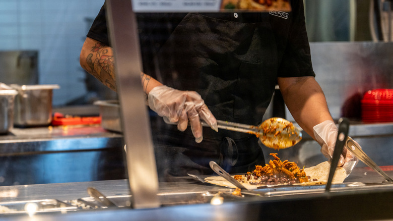 Chipotle server preparing food