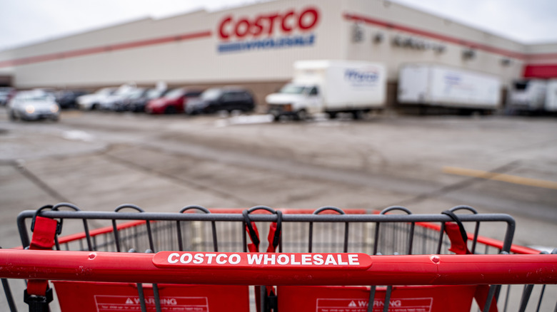 A close up shot of a Costco shopping card has a blurry Costco in the background.