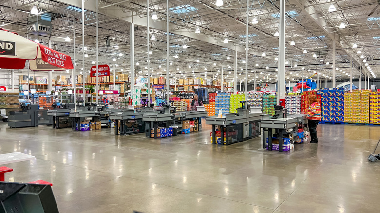 A Costco checkout aisle has one customer in line.