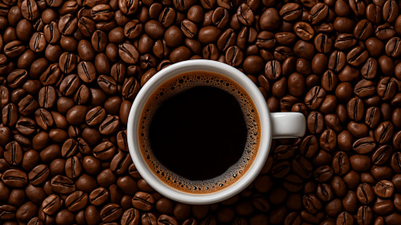 A cup of coffee on a coffee bean background