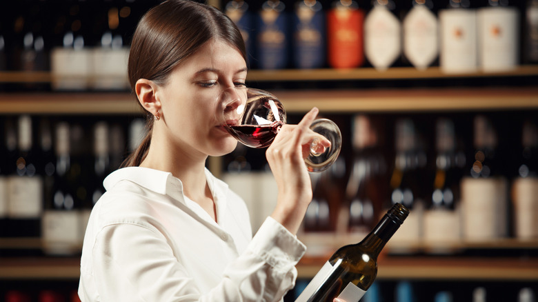 Woman tasting red wine