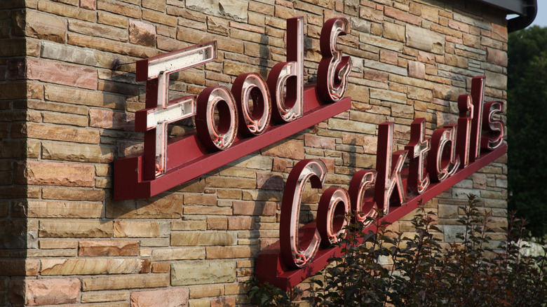 retro food and cocktails signage outside supper club