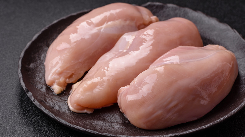 A plate of raw chicken breast
