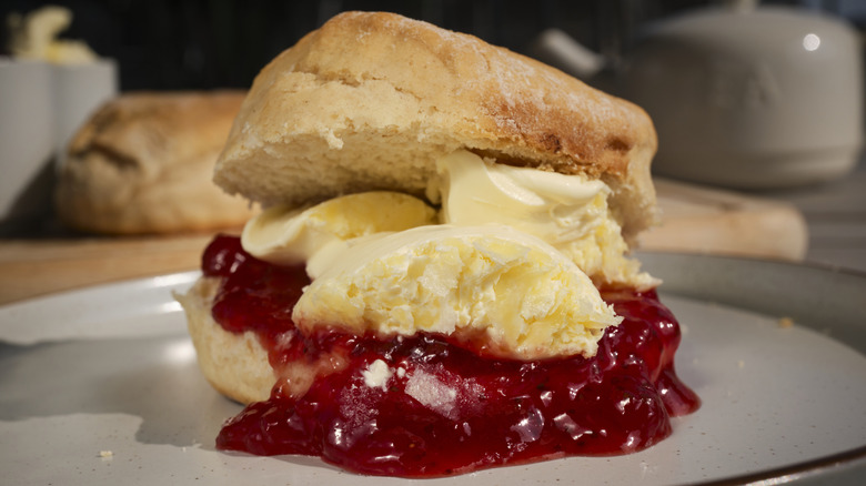 Clotted cream on scone with jam