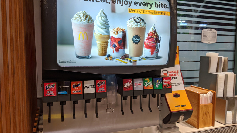 A fountain drink machine inside a McDonald's store