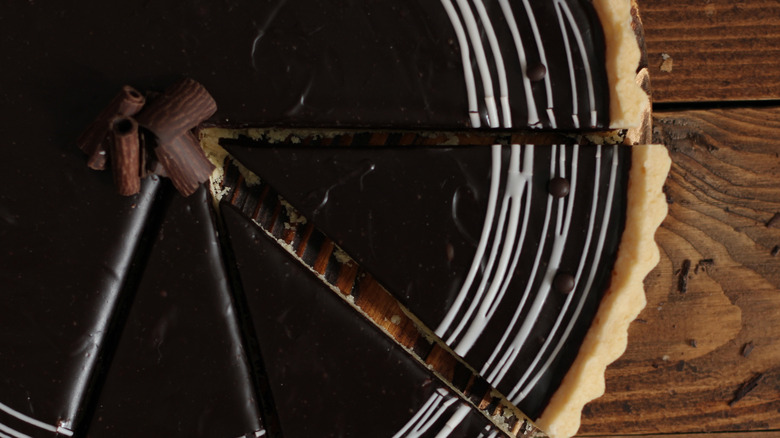 A close up shot of a dark chocolate ganache tart