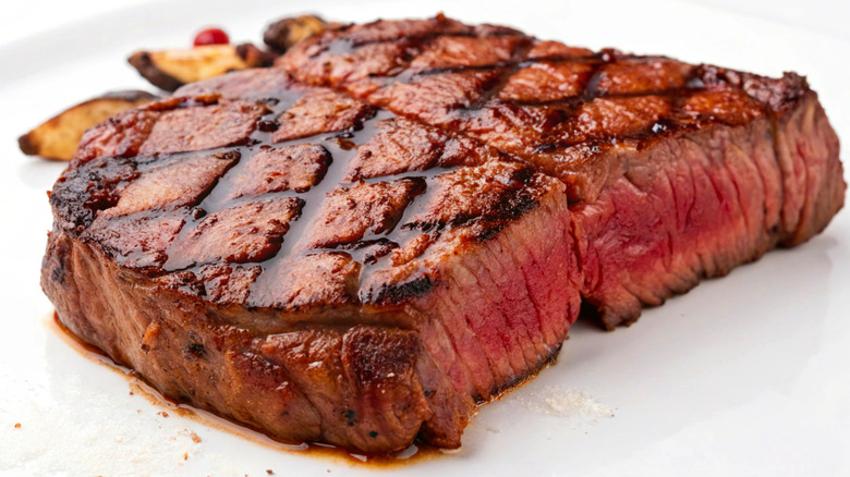 Steak on white plate with grill marks