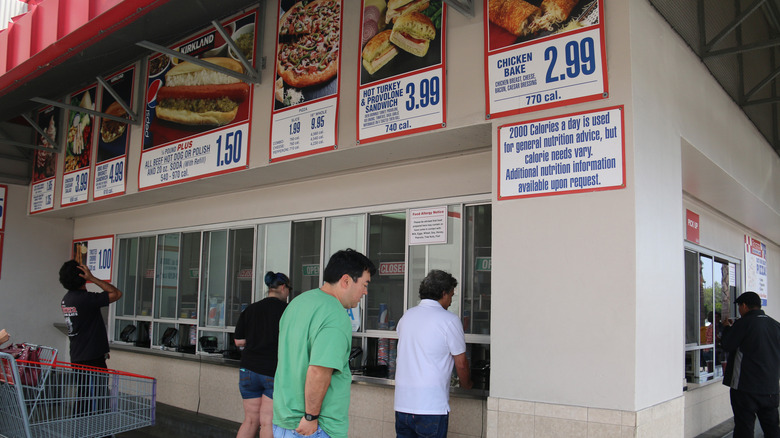 An outdoor Costco food court in 2016, featuring the BBQ brisket sandwich on its menu.