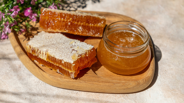A jar of buckwheat honey and two slabs of honeycomb