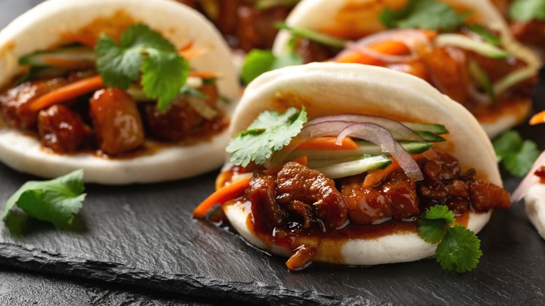 Bao buns stuffed with pork belly and vegetables.
