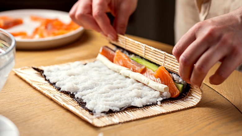 Person rolling sushi