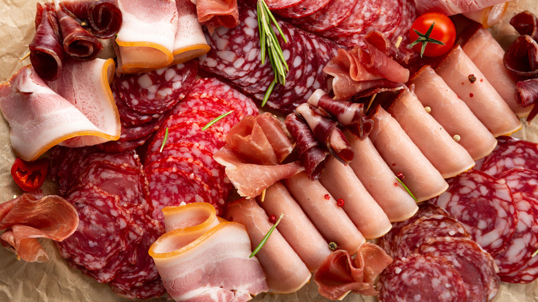 A plate of antipasto with herbs and cherry tomatoes
