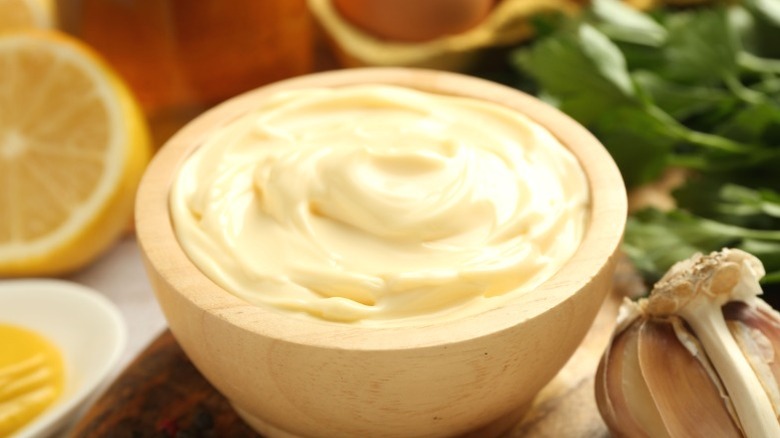 Mayonnaise in a small wooden bowl.