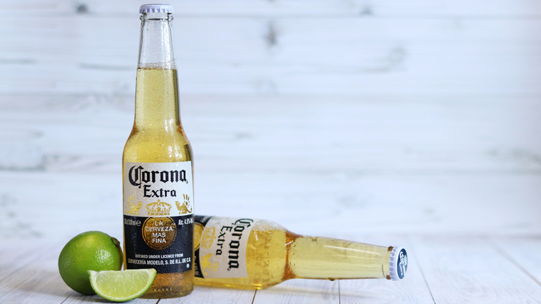 Bottle of Corona beers alongside fresh limes