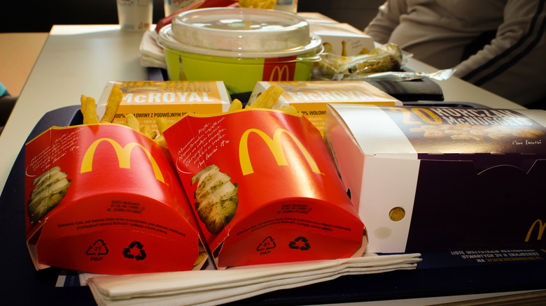 McDonald's fries, McNuggets, and other menu items serviced in a tray atop a store table.