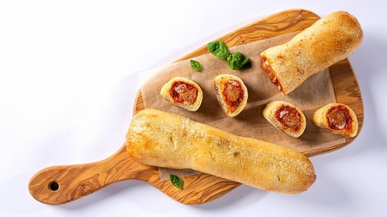 Meatball Panino Stuffed Italian-Style Rolls on a wooden cutting board