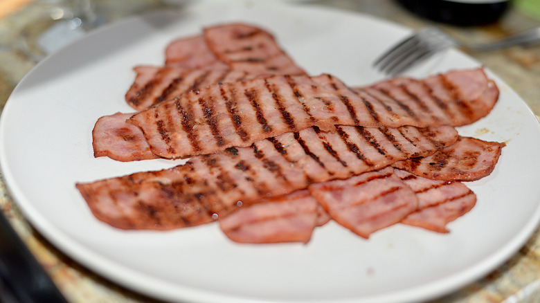A plate of turkey bacon with grill marks