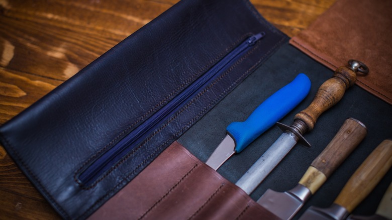 A leather knife roll with tools inside