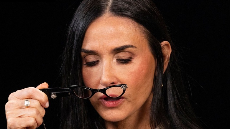 Demi Moore reading hot sauce bottle