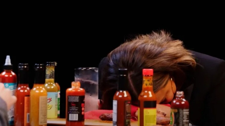 Guest of Hot Ones passed out on table