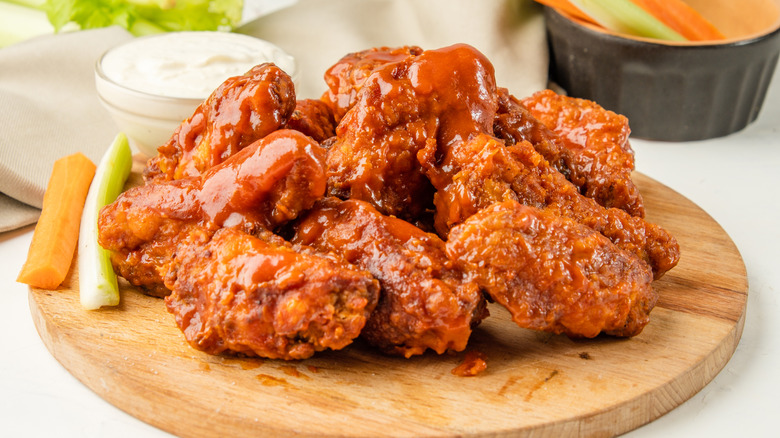 Hot wings on a wooden plate
