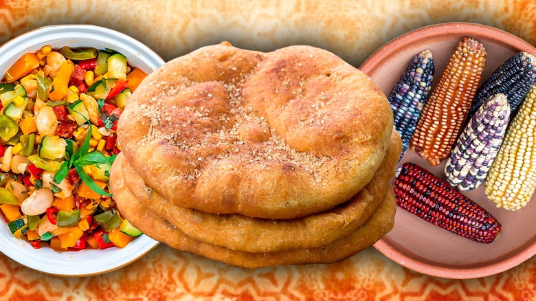 Succotash, bread, and different colored ears of corn