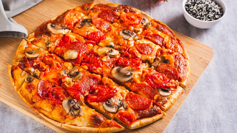 square cut pizza on cutting board