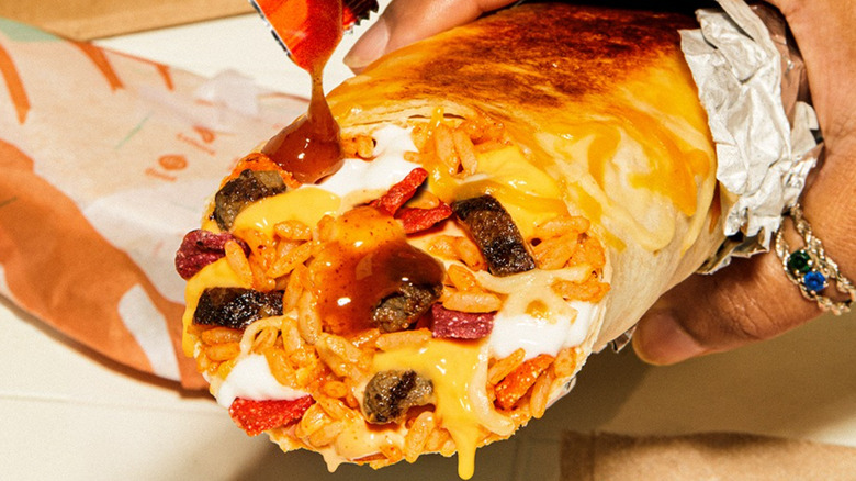 Hand holding Taco Bell steak burrito