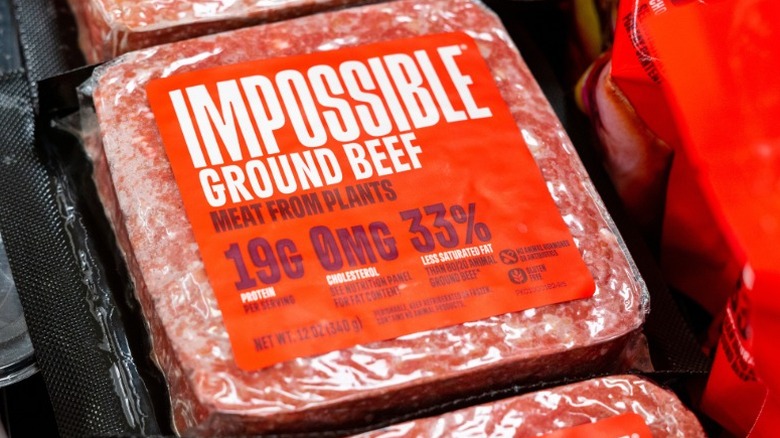 a pack of Impossible brand plant-based ground beef displayed in a grocery store