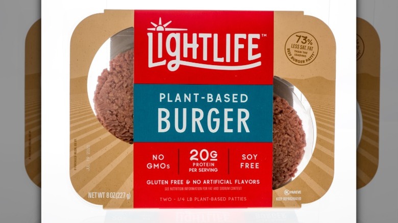 A package of LightLife plant-based burger patties isolated on a white background