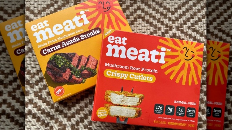 a pack of Meati plant-based carne asada steaks and plant-based crispy cutlets on a patterned, brown and white background