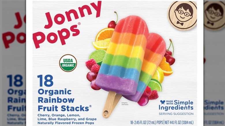 A box of colorful rainbow popsicles and two popsicles of the same type