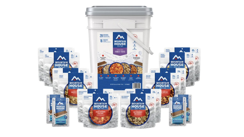 A large Mountain House storage bucket surrounded by food packets