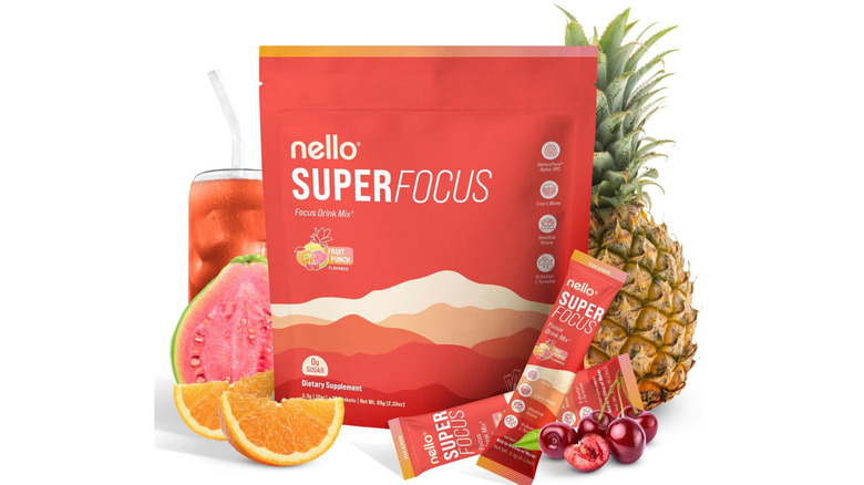 A package of Nello Superfocus packets next to some fruit and a drink on a white background.
