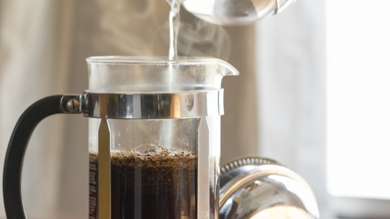 pouring water into French press coffee maker