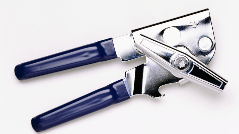 A clean metal can opener with blue plastic handles