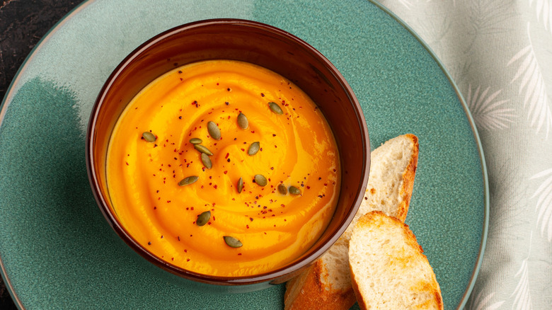 Butternut squash soup on a plate with toasted bread