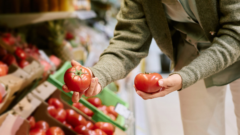 Selecting tomatoes at the grocery store