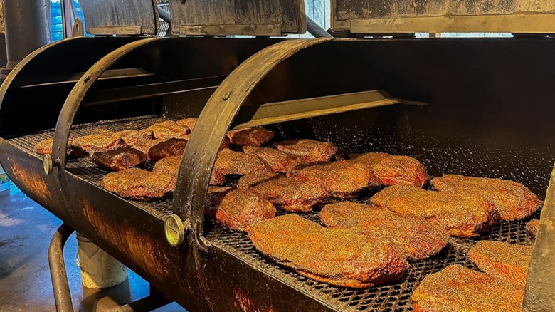 Seasoned meat on a smoker at Terry Black's Barbecue