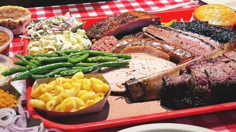 BBQ meats and sides from Terry Black's Barbecue on a red tray.
